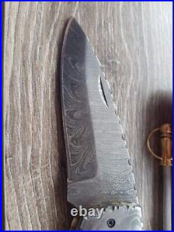 A folding pocket knife handmade from Damascus steel