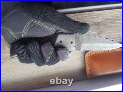 A folding pocket knife handmade from Damascus steel