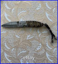 Handmade damascus steel folding blade knife (Wooly Mammoth Tooth Handle)