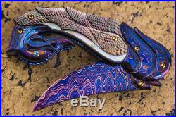 Suchat Jangtanong Custom Folding Knife Color Damascus Steel Carved as Swan Topaz